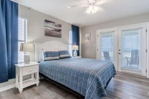 a bedroom with a bed and a ceiling fan at Bonhomme Richard East in Gulf Shores