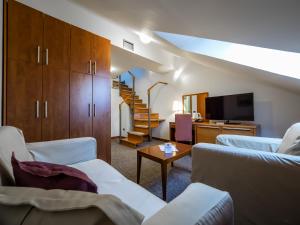 a living room with two couches and a staircase at Garni Hotel Le Petit Piaf in Belgrade