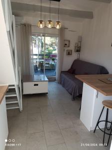 a living room with a couch and a table at studio au cap d'agde dans les pinèdes in Cap d'Agde