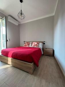 a bedroom with a large bed with a red blanket at HappyHome Rivarolo 6 posti letto in Rivarolo Canavese