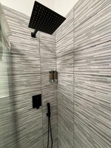 a bathroom with a shower with a light on the wall at HappyHome Rivarolo 6 posti letto in Rivarolo Canavese