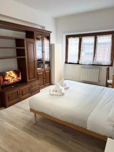 a bedroom with a large bed and a fireplace at Cerreto Suite Housing in Rome