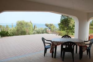 stół i krzesła na patio w obiekcie Nuovissimo appartamento a due passi dalla spiaggia di Maladroxia C61 w mieście Maladroscia
