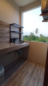 a bathroom with a sink and a window with a toilet at B House Phuket @Chalong in Chalong 