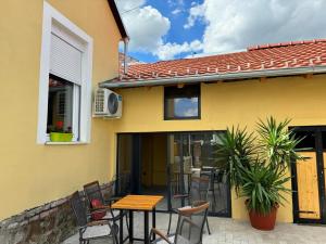 a patio with chairs and a table in front of a house at DANA GUEST HOUSE in Sremski Karlovci