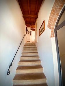 a staircase leading up to a building with a brick ceiling at Mansarda Isabella in Linari