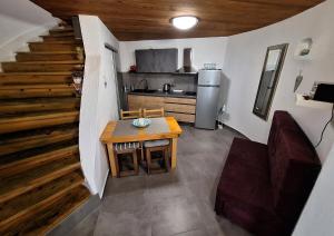a kitchen with a table and a refrigerator and stairs at Old Mill in Rogoznica
