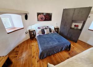 a bedroom with a bed and a wooden floor at Old Mill in Rogoznica