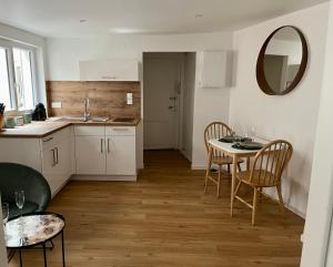 a kitchen with a table and chairs and a mirror at Le XVII - Au cœur de Colmar in Colmar