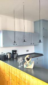 a kitchen with a counter with wine glasses on it at Bright, Modern and Spacious - Apartment "Lola" Family & Workplace in Gießen