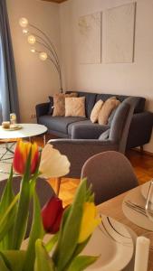 a living room with a couch and a table at Bright, Modern and Spacious - Apartment "Lola" Family & Workplace in Gießen