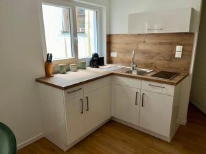 a small kitchen with a sink and a window at Le XVII - Au cœur de Colmar in Colmar +10 photos