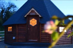 a model of a wooden cabin with a blue roof at Apple blossom glamping in Kilkenny
