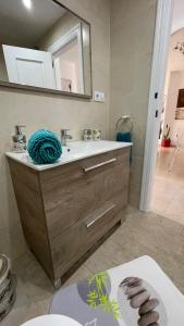 a bathroom with a sink and a mirror at CASA EVA Naturista, Vera Playa in Playas de Vera
