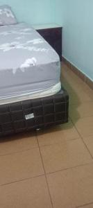 a mattress sitting on a tiled floor in a room at San Miguel Hostal in Villarrica