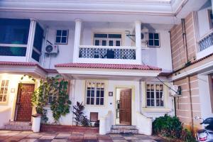 a white house with two balconies on top of it at paradise villa in Varca