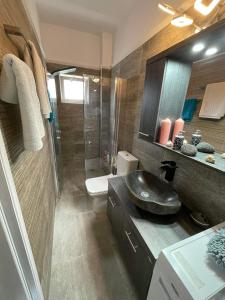 a bathroom with a sink and a shower at Vikis Dream Views in Skala Mistegnon
