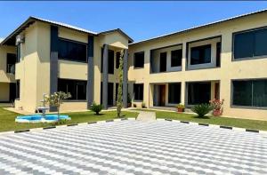 a house with a courtyard in front of it at Eleganciana Lodges Limited in Lusaka