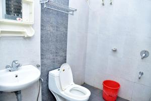 La salle de bains est pourvue de toilettes blanches et d'un lavabo. dans l'établissement paradise villa, à Varca