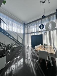a dining room with a wooden table and chairs at Two Bedroom Villa with Private Pool & Garden by Olivujoj in Anavyssos