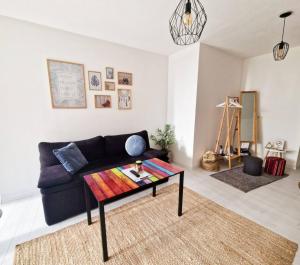 a living room with a couch and a coffee table at Studio Apartment Bohemia in Mostar