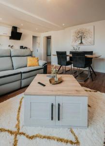 a living room with a couch and a table at Appartement T3 Hyper centre Saumur in Saumur