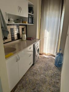 a kitchen with a sink and a washing machine at В центре города in Antalya