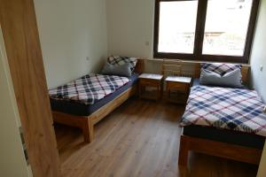 a room with two beds and a window at Ferienwohnung Hilberath in Wimbach