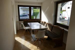 a dining room with a table and chairs and a window at Ferienwohnung Hilberath in Wimbach