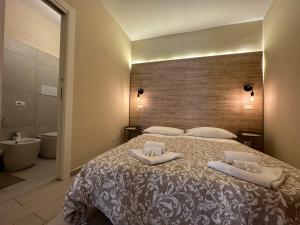 a bedroom with a large bed with two pillows on it at Santa Lucia in Caltanissetta
