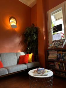 a living room with a couch and a table at Hôtel de Caen in Caen