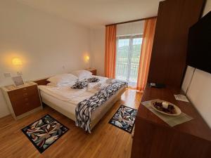 a small bedroom with a bed and a window at B&B Kovač in Portorož