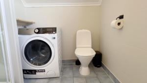 a bathroom with a washing machine and a toilet at House with perfect location in Leknes in Leknes