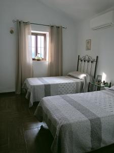 a room with two beds and a window at Casa Rueapara in Torrox