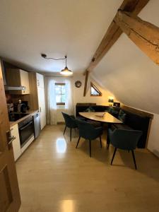 a kitchen and dining room with a table and chairs at Ferienwohnung Aigner in Schellgaden