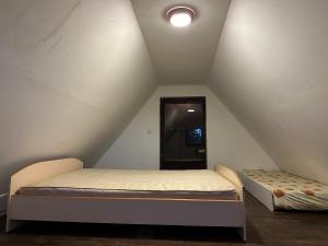 a room with two beds in a attic at Vila Varadero in Skopje