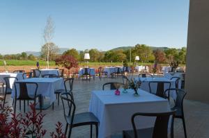a group of tables and chairs with white table cloth at Tenute Masullo in Pedale