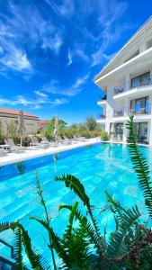 a large swimming pool in front of a building at Payava Hotel by True Blue in Kalkan