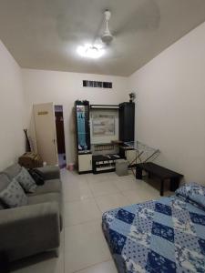 a living room with a couch and a tv at Fully furnished room in Sharjah