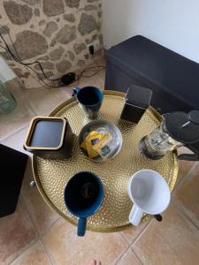 a table with a cell phone on top of it at chambre Saint Malo in Saint-Méloir-des-Ondes