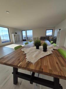 a living room with a wooden table with feathers on it at Yggdrasil Sea View Lodge in Tromsø