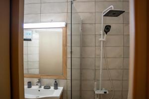 a bathroom with a shower and a sink at Perikleous 5 Diamerisma KONDOULIS HOUSE in Kalabaka +14 photos