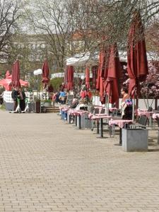 a group of tables with red umbrellas in a park at SUITE Top View & City Alex 4 rooms 2 bathrooms 1 kitchen in Berlin