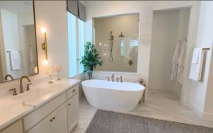 a white bathroom with a large tub and a sink at Pitso aparhotel in Johannesburg +5 photos