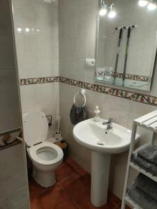 a bathroom with a toilet and a sink and a mirror at Agata 6 - 24h reception in Benalmádena +10 photos