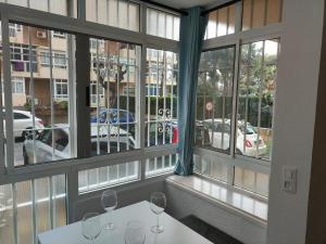 a room with a window with wine glasses on a table at Agata 6 - 24h reception in Benalmádena