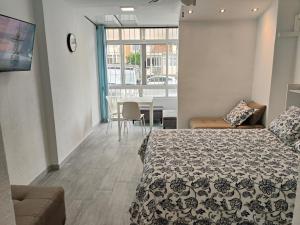 a bedroom with a bed and a dining room at Agata 6 - 24h reception in Benalmádena
