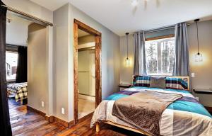 a bedroom with a bed and a large window at The Big Jack Chalet 33 Chemin Blanc by Les Chalets Alpins in Stoneham +70 photos