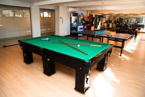 a ping pong table in a room with two tables at Foz Plaza Hotel in Foz do Iguaçu