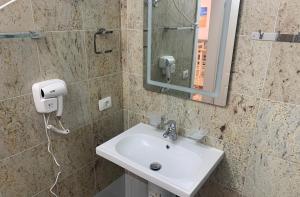 a bathroom with a sink and a mirror at Fishta Quality Apartments Q5 31 in Velipojë +8 photos